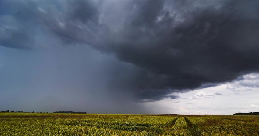 Storm clouds over field, tornadic supercell, extreme weather, dangerous storm Royalty-Free Stock Footage #1092357987