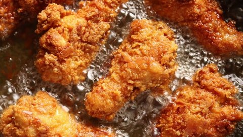 Top view of Crispy Chicken Drumsticks are Fried in Boiling Oil Adlı Stok Video