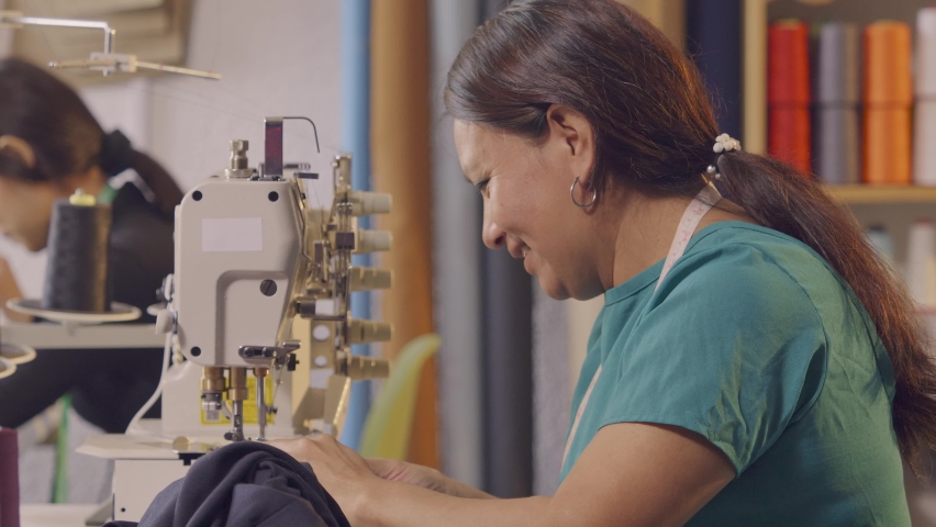 Latin women use a sewing machine in their craft workshop. | Shutterstock HD Video #1092375449