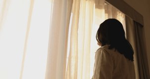 4K Video slow motion asian woman open the door on the morning with sunrise. Concept for new day fresh and happiness.