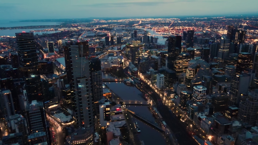 Beautiful aerial drone pullback reverse view of Melbourne City, Victoria, Australia above the Yarra River in the very early morning at dawn 