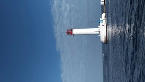 view of the sea lighthouse from a moving ship vertical frame
seascape with lighthouse camera movement