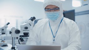 Portrait of an Engineer in White Safety Coverall Working on Laptop Computer at Electronic Manufacturing Factory. Technician Working on Daily Tasks and Inserting Analytic Science Data. - Powered by Shutterstock - Get 15% off with code: PIKWIZARD15