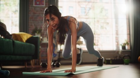Beautiful AthleticSports Woman, Does Aerobic Exercises Workout, Doing Mountain Climber Running on Spot at Home. Ground Shot Beauty Portrait in Stylish Slow Motion Adlı Stok Video