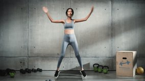 Online Workout Service: Professional Female Training, Exercises. Strong Fit Asian Woman Doing Jumping Jacks. Stylish Minimalistic Background. Slow Motion Cinematic Wide Portrait - Powered by Shutterstock - Get 15% off with code: PIKWIZARD15