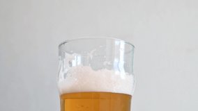 Cold light Beer flowing in a glass. 4k video in slow motion 