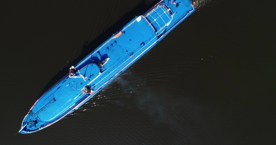 The blue river boat go forward. Divorces on the water. Background, aerial top shot in 4K
