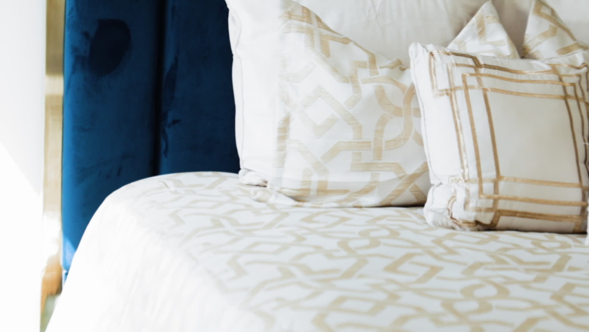 Panning view of beautiful pillows in bed
