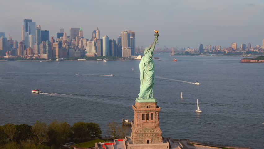 Aerial View of an Iconic Statue of Liberty, New York Harbor. Famous Landmark. Symbol of West Values - Freedom, Resistance to Oppression, Independence. Panoramic Orbital Shot Royalty-Free Stock Footage #1092397907