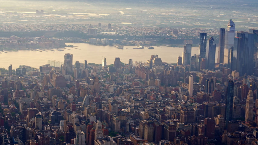 Aerial View of a New York Manhattan Financial District Filmed From a Helicopter at Sunset. Urban Cityscape. Wide Panoramic Shot