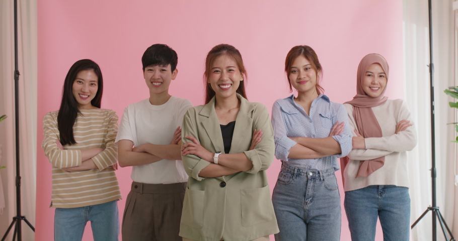 Diverse group of young asia Gen z girl arm cross happy face look at camera in model shooting studio shot. Power of people woman's day right or gay youth LGBT pride unity team strong cool proud smile. | Shutterstock HD Video #1092399165