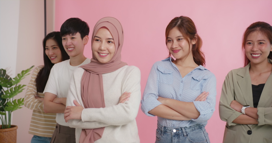 Diverse group of young asia Gen z girl arm cross happy face look at camera in model shooting studio shot. Power of people woman's day right or gay youth LGBT pride unity team strong cool proud smile. | Shutterstock HD Video #1092399169