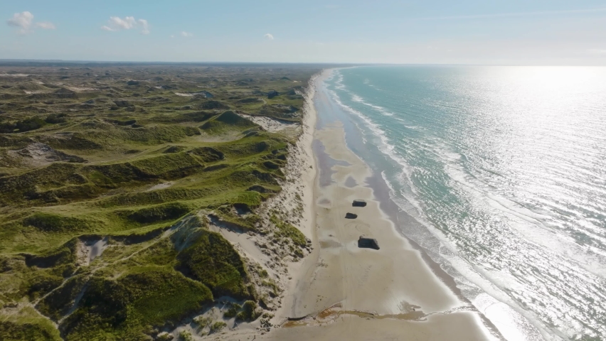 Panoramic view, sand dunes, the World War II bunkers on a beach, and views of the North Sea. Royalty-Free Stock Footage #1092401467