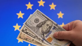 Dollar bills on EU flag background in men's hands - Powered by Shutterstock - Get 15% off with code: PIKWIZARD15