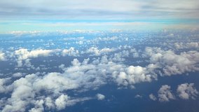 Cumulus Clouds Scattered Across Blue Sky with Bird's-eye View Seen Through Airplane Window Above Vast Ocean Underneath. Heaven Perspective at High Altitude - POV - Powered by Shutterstock - Get 15% off with code: PIKWIZARD15