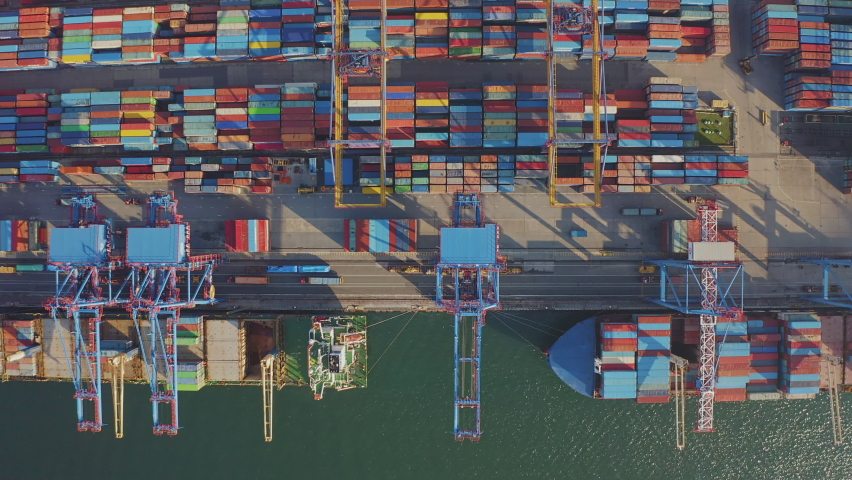 Loading and unloading a container ship in the port at the pier. Aerial view of business logistics import and export cargo transportation by container ship. Containers on a cargo vessel Royalty-Free Stock Footage #1092414503