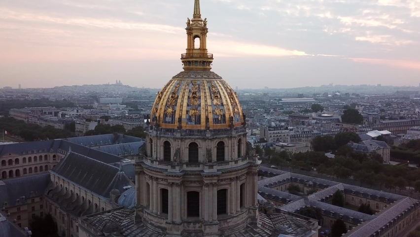 Aerial Orbit of Les Invalides Golden Dome at sunrise, Revealing Eiffel Tower in the Paris city in background. Famous Tourist Attraction in 4k