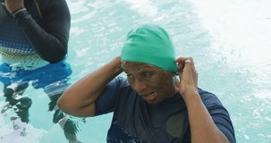 Video of happy african american couple swimming in the pool. Senior lifestyle, retirement lifestyle, active leisure time.