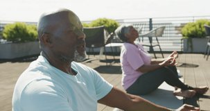 Video of relaxing senior african american couple meditating in the garden. Retirement lifestyle, active leisure time.