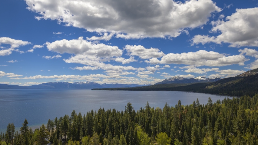 Timelapse of clouds moving over Lake Tahoe, California, with Sierra Nevada Mountains in the background. 4K UHD video.