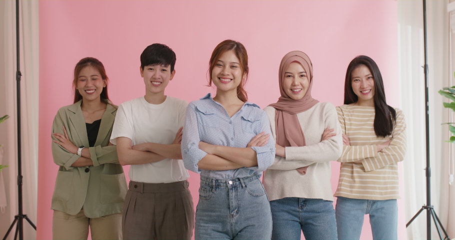 Diverse group of young asia Gen z girl arm cross happy face look at camera in model shooting studio shot. Power of people woman's day right or gay youth LGBT pride unity team strong cool proud smile. | Shutterstock HD Video #1092428119