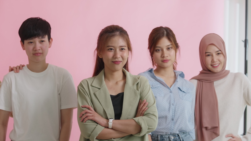 Diverse group of young asia Gen z girl arm cross happy face look at camera in model shooting studio shot. Power of people woman's day right or gay youth LGBT pride unity team strong cool proud smile. | Shutterstock HD Video #1092428121