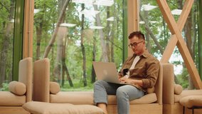 Asian man using laptop close-up, coworking workspace. Korean young guy working remotely on computer in cafe. Remote work, business. Student communicating with family and friends online, chatting. - Powered by Shutterstock - Get 15% off with code: PIKWIZARD15