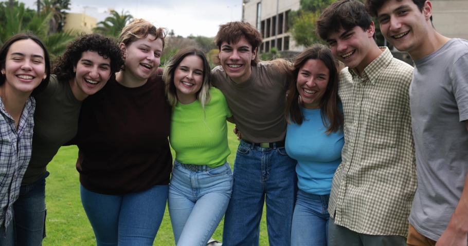 Young group of students friends having fun outdoor with university in background 