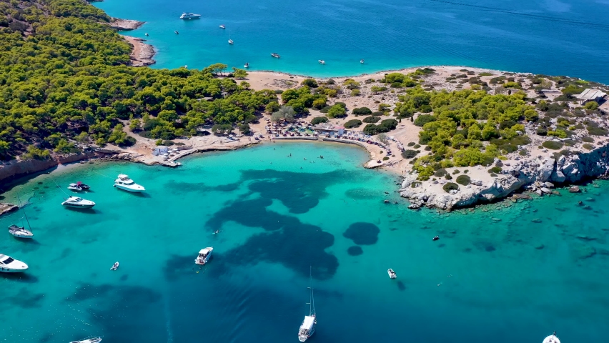 Panoramic aerial view of the popular beach of Moni island, next to the village Perdika on Aegina island with turquoise sea, Saronic Gulf, Greece
