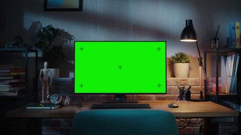 Zoom in On a Modern Personal Computer Monitor with Chroma key Green Screen Display Standing on the Desk of a Cozy Home Office. Living Room Created by Interior Designer with Good Taste and Style.