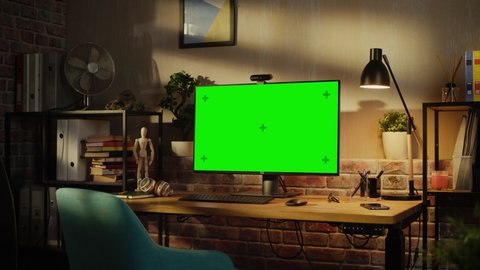 Zoom in On a Modern Personal Computer Monitor with Chroma key Green Screen Display Standing on the Desk of a Cozy Home Office. Living Room of Interior Designer with Good Taste and Creative Atmosphere.
