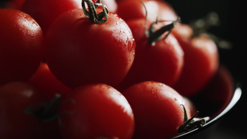 Cherries tomatoes in rotation move on black background Royalty-Free Stock Footage #1092459765