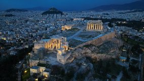 Night drone view of downtown Athens, night view of Acropolis in Athens, aerial view of illuminated Parthenon in Athens in the evening, unesco heritage site in Greece. High quality 4k footage