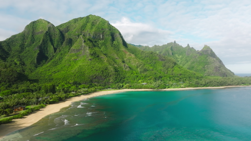 Cinematic Hawaii nature landscapes. Scenic NaPali coast with beautiful ridges jungle mountains. Incredible scenery of green lavish tropical peaks over turquoise ocean. Summer travel aerial background  Royalty-Free Stock Footage #1092470539