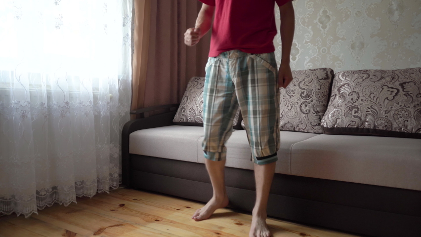a man is dancing,young man dancing in the room