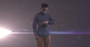Animation of african american businessman using smartphone over glowing stars. Global technology, business, finance and data processing concept digitally generated video.