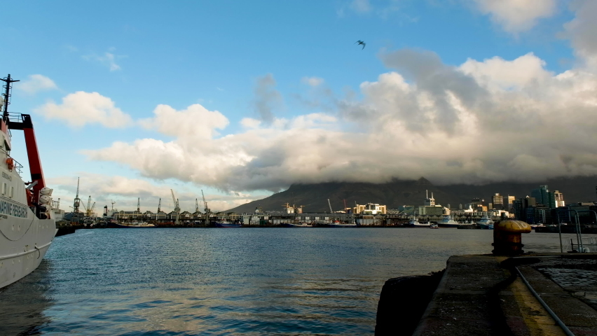 View over port of Cape Town, with low clouds covering Table Mountain