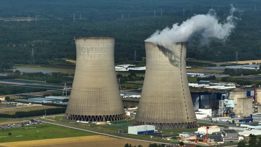 Aerial view to nuclear power plant in France. Atomic power stations are very important sources of electricity with low carbon footprint. Aerial view to big source of emissions in European Union Royalty-Free Stock Footage #1092494009