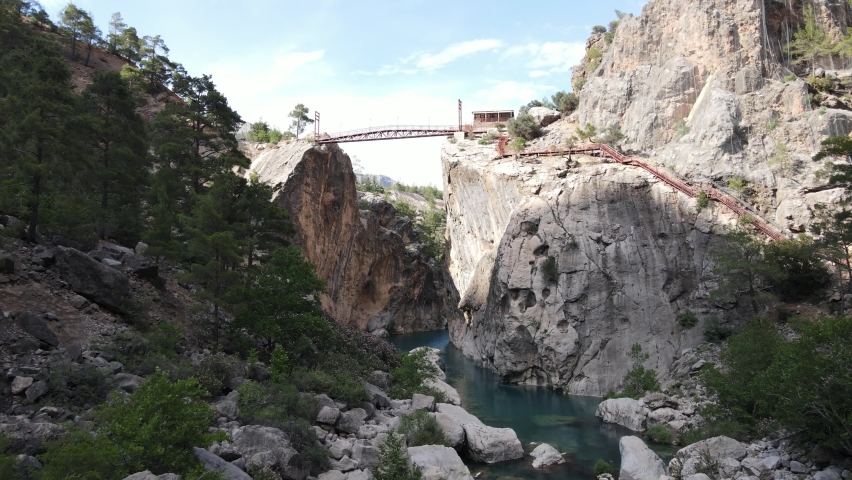 Drone view of the stream passing through the hard rocks, view of the Yerkopru national park canyon, the view of the waterfall flowing through the gray cliffs