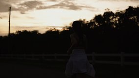 Silhouette video of healthy women is evening running and golden sunset background.