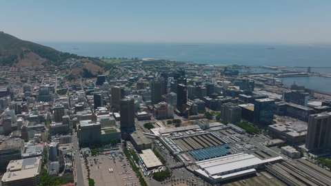 Aerial view of downtown buildings and Main train station. Calm sea in background. Cape Town, South Africa