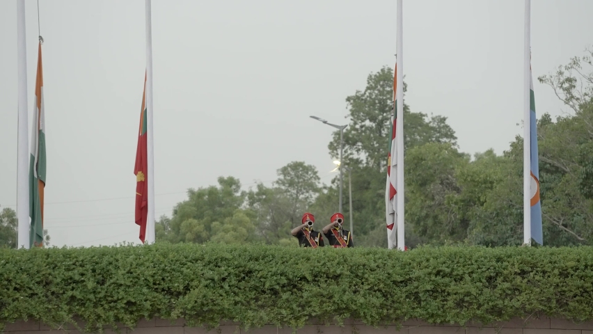 Soldiers Playing Trumpet While Lowering The Flags At National War Memorial In New Delhi, India. - wide