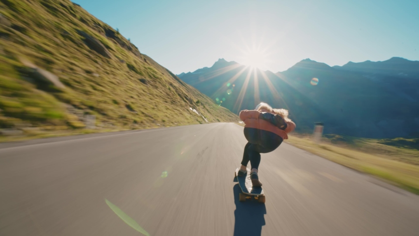 Cinematic downhill longboard session. Young woman skateboarding and making tricks between the curves on a mountain pass. Concept about extreme sports and people Royalty-Free Stock Footage #1092503295