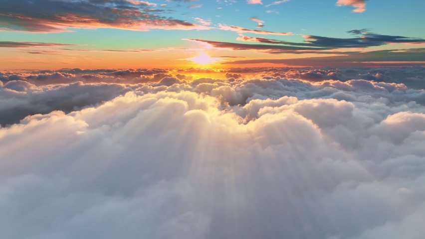 Gorgeous sunset above the clouds in the sky. Sunrays breaking through the clouds. amera rises above the clouds to see the bright sunset sky and the sun Royalty-Free Stock Footage #1092505007
