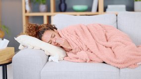 Sick woman resting with a cold or flu on the couch at home alone. Black female coughing, looking restless, and trying to sleep while lying on the sofa in the living room. Girl recovering from covid - Powered by Shutterstock - Get 15% off with code: PIKWIZARD15