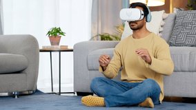 Male gamer using a VR headset to access the metaverse while gaming online at home. Young man enjoying video games with wireless headphones while entering an immersive 3D virtual reality experience - Powered by Shutterstock - Get 15% off with code: PIKWIZARD15