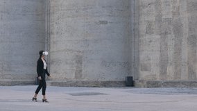Woman exploring the metaverse using VR glasses while walking outside. Female with ai 3D goggles, talking and interacting with virtual reality. Woman having a digital video call using AR headset. - Powered by Shutterstock - Get 15% off with code: PIKWIZARD15