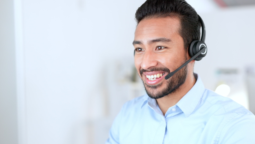 Male customer service representative giving advice to people and helping them with IT support. Closeup of the face of a young call center agent talking to a client and answering questions online. | Shutterstock HD Video #1092513889