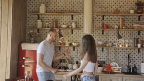 Man and woman having fun in vintage kitchen. Zoom out and in merry couple dancing together in retro kitchen on sunny weekend day at home
