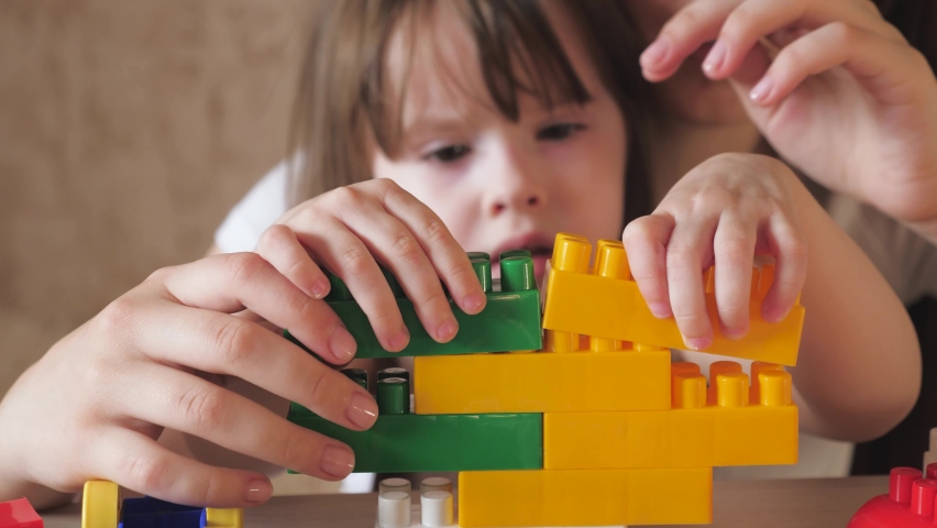 Children game. kid dreams building. child care. cognitive colorful development baby girl. classes with designer in kindergarten. playful child imagining tower building strategy. work group team | Shutterstock HD Video #1092515123